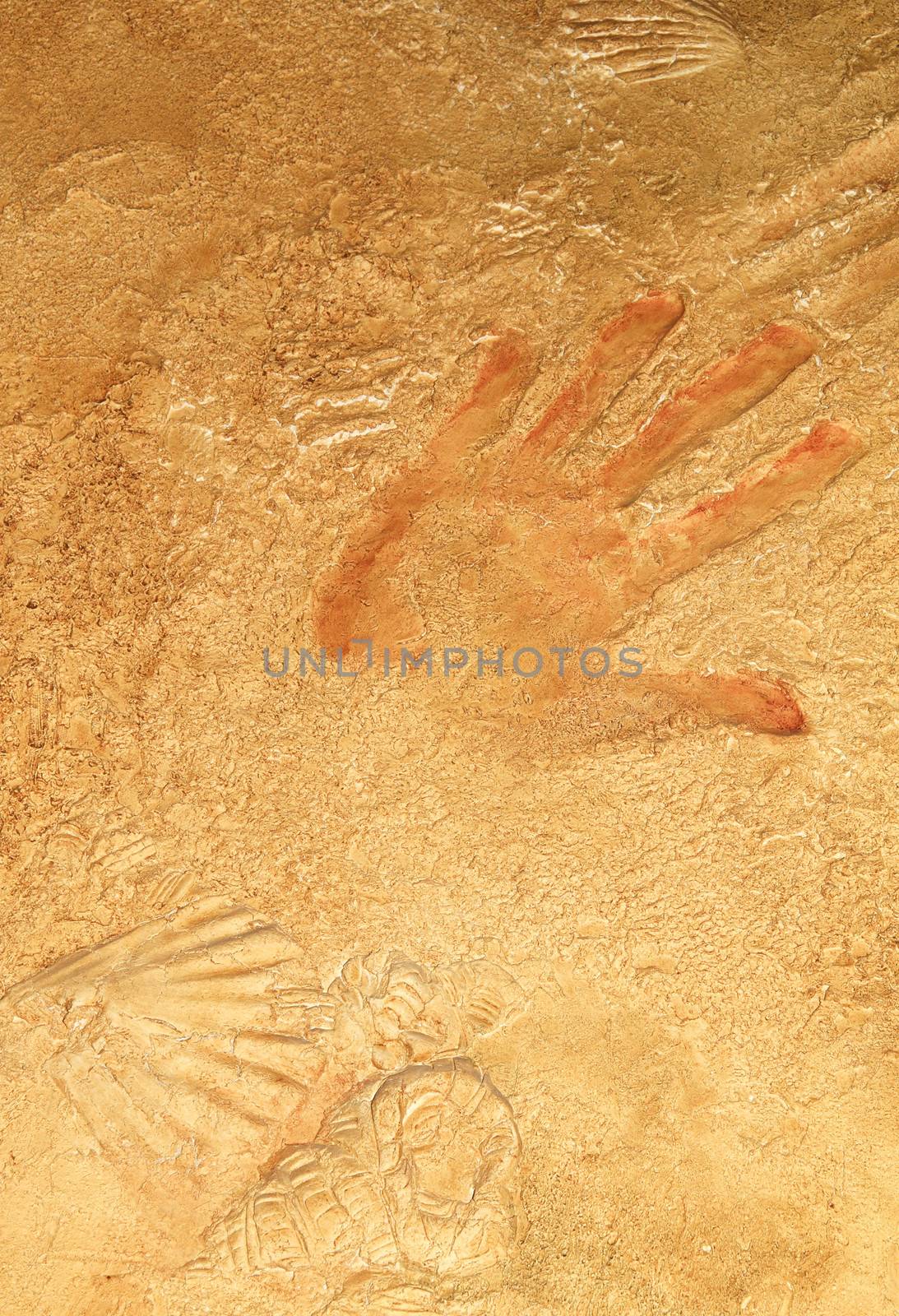 Red hand print on stone