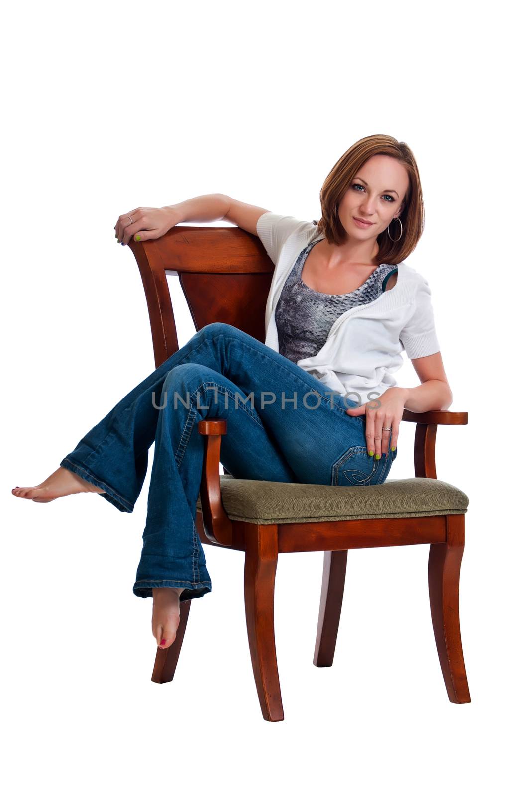 Pretty young woman resting with her legs up in an arm chair.