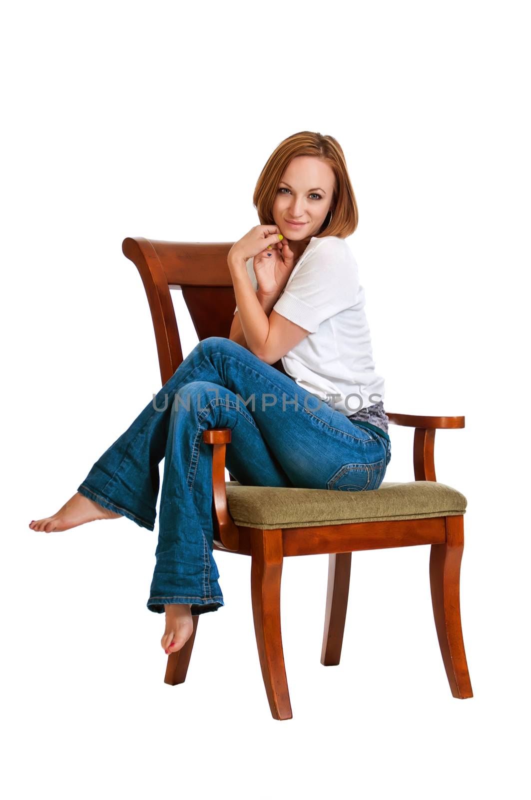 Beautiful brunette girl resting with her legs up on an arm chair.