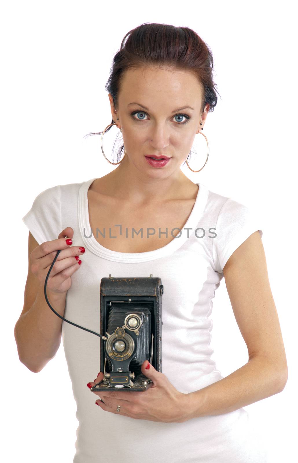 Pretty young woman in her 20's holding an antique folding camera