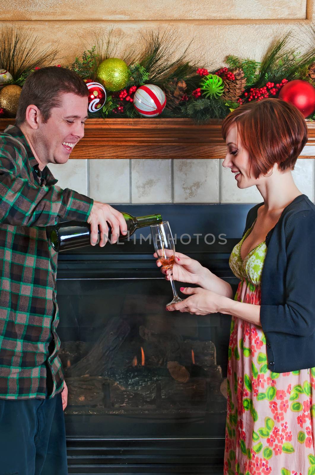 Young couple enjoying a glass of wine at Christmas time