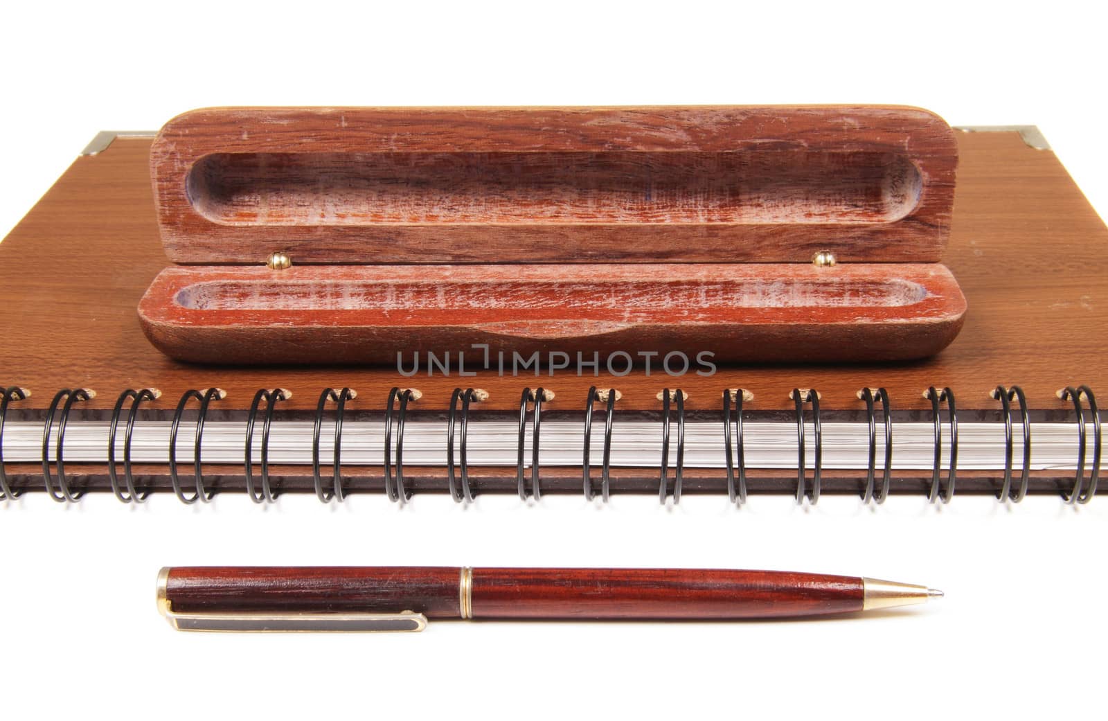 pen in an opened wooden case on notebook