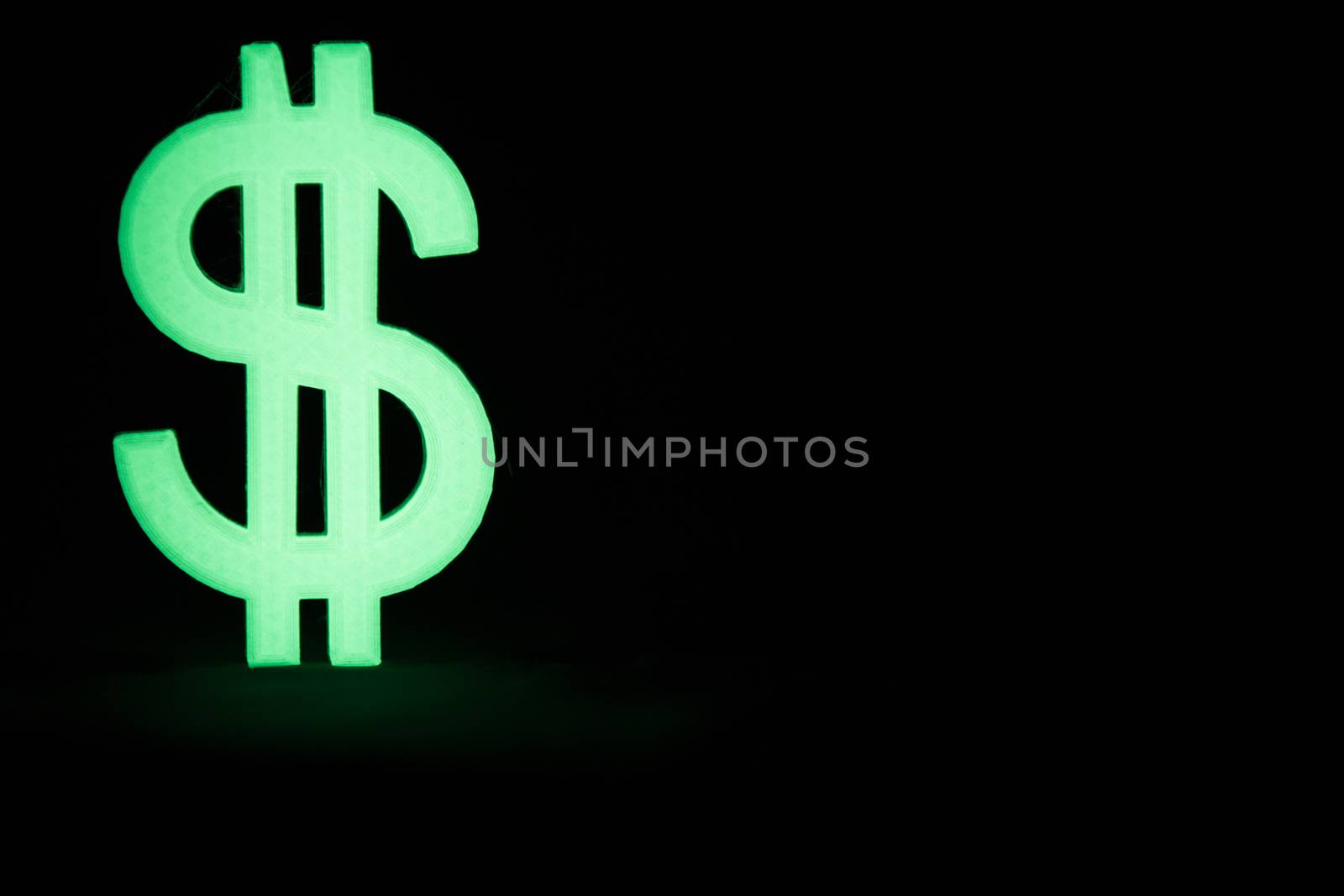 Glowing Dollar sign in the dark with black background
