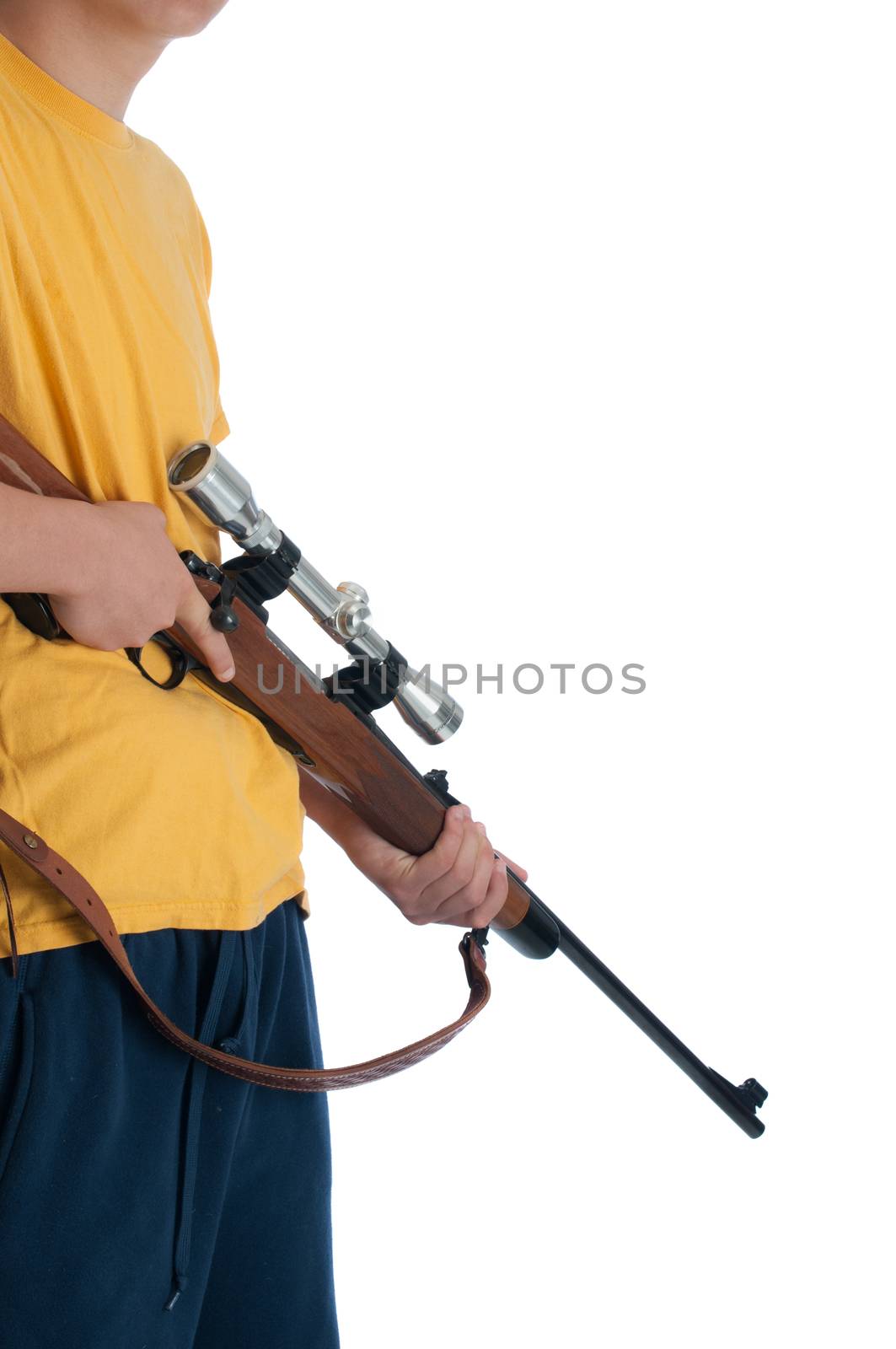 Teenage boy holding a high power hunting rifle.