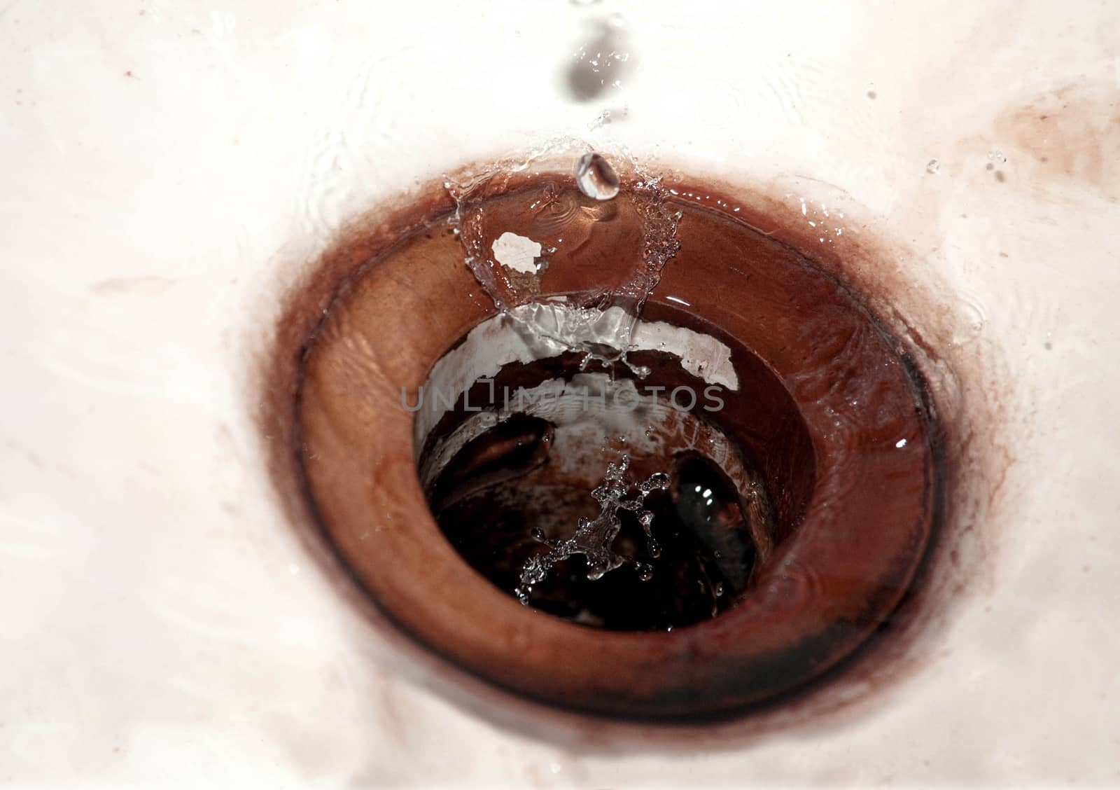 Waterdrops falling into vintage sink