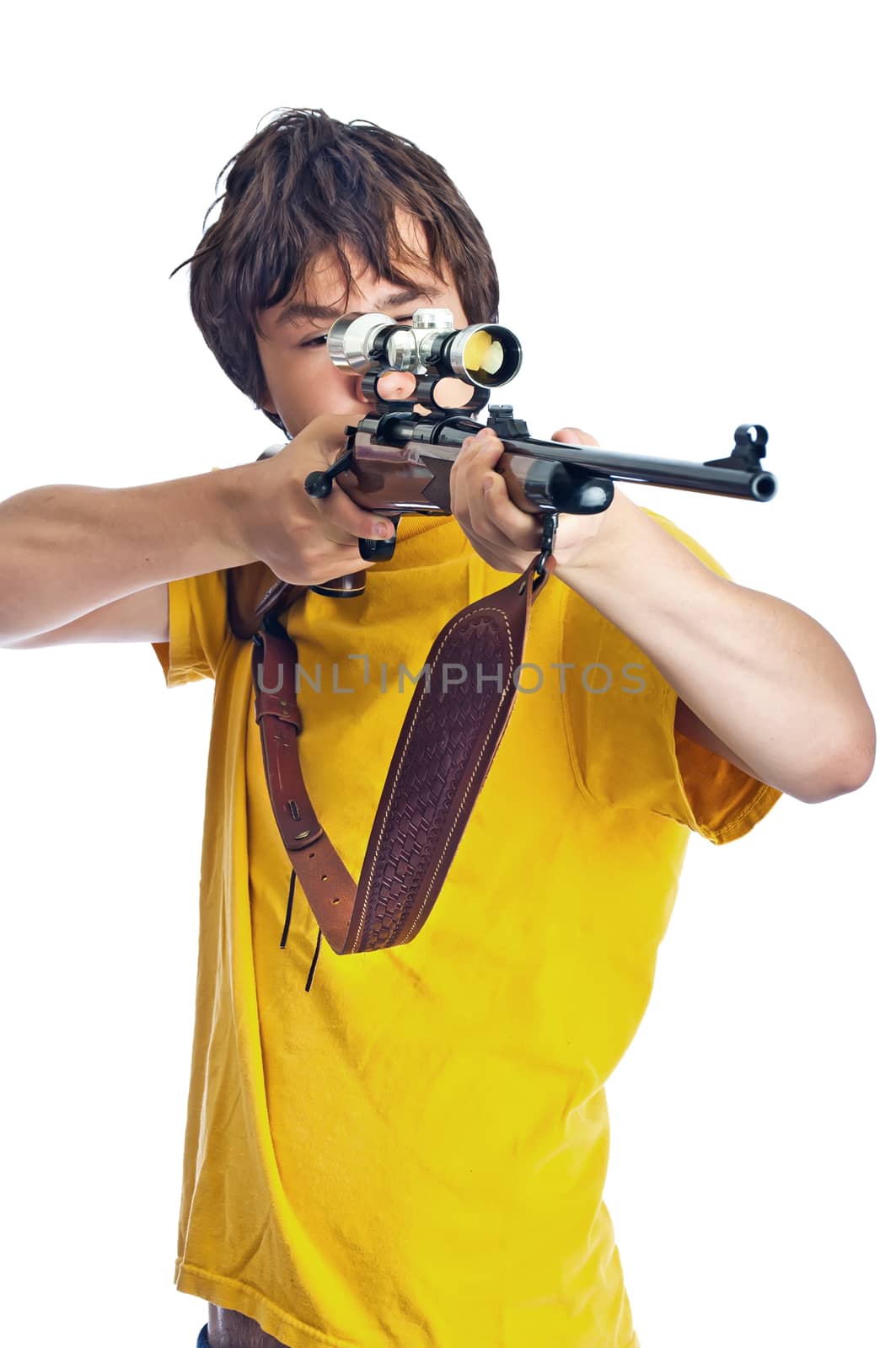 Young adult male pointing a 30-06 hunting rifle, aiming with a scope. Isolated on white