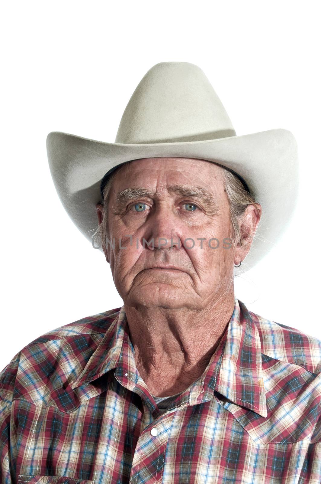Cowboy with the years of experience written in the lines of his face.