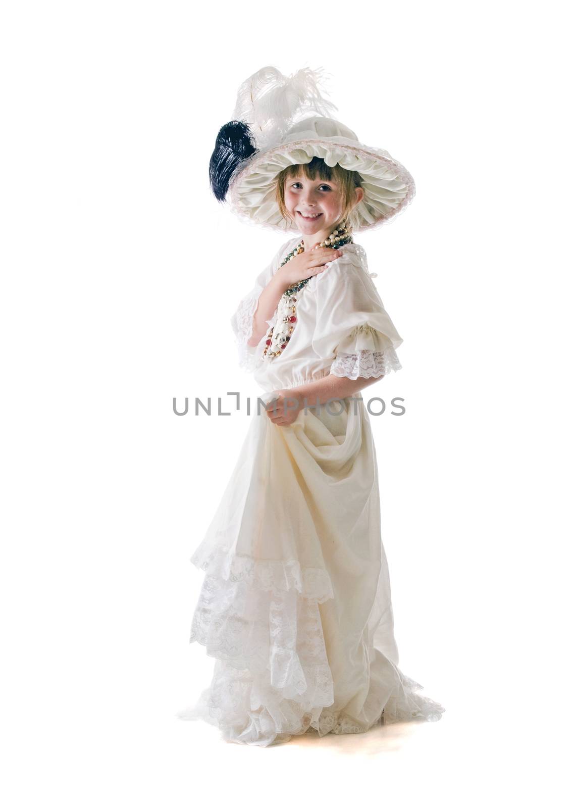 Pretty little girl enjoying Grandma's hat and dress to play dress-up in.