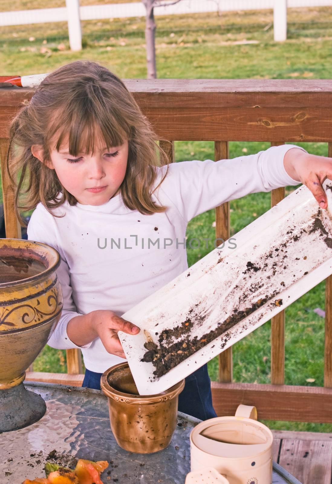 Little Girl Playing With Planters And Soil by rcarner