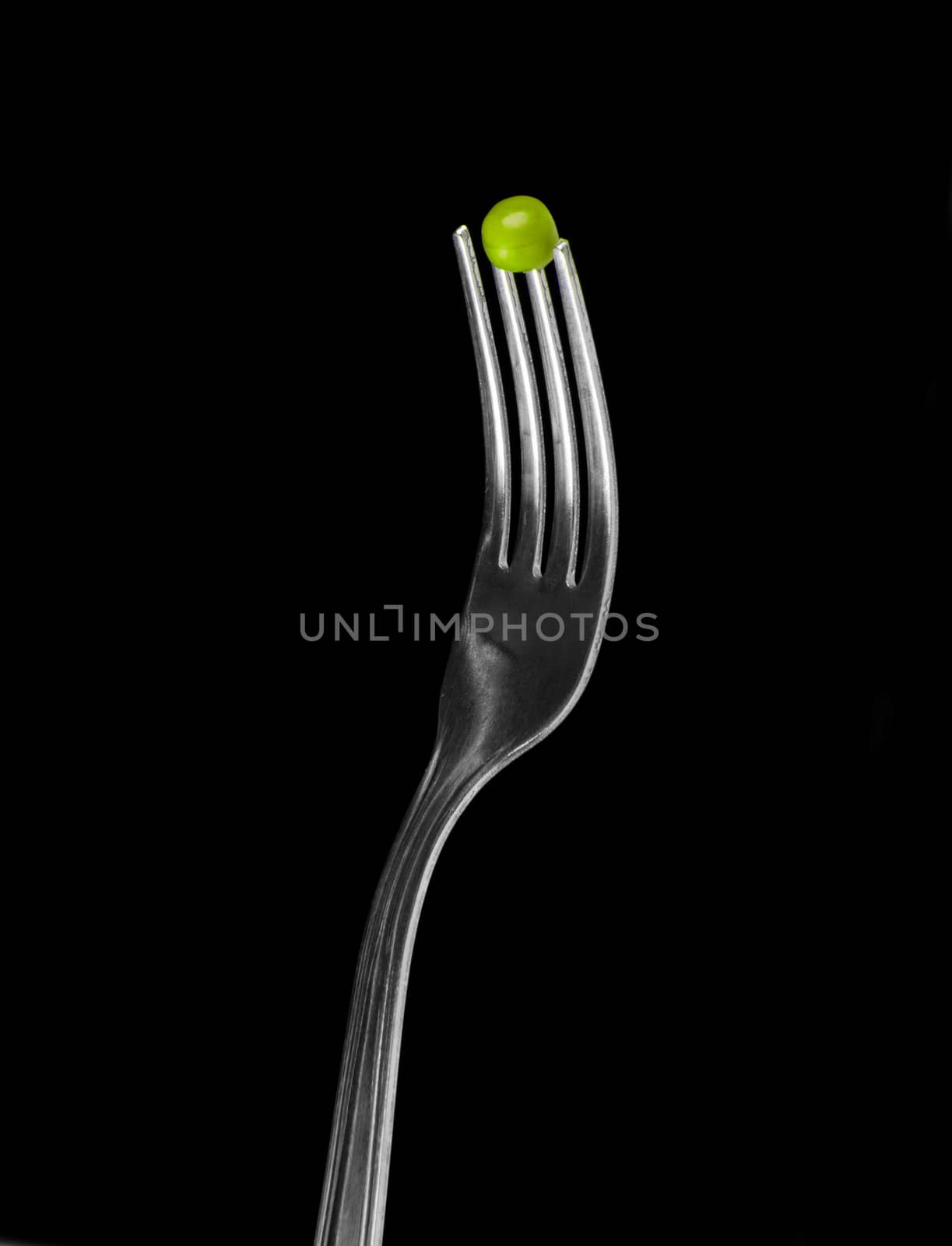 Fresh green peas on a silver fork