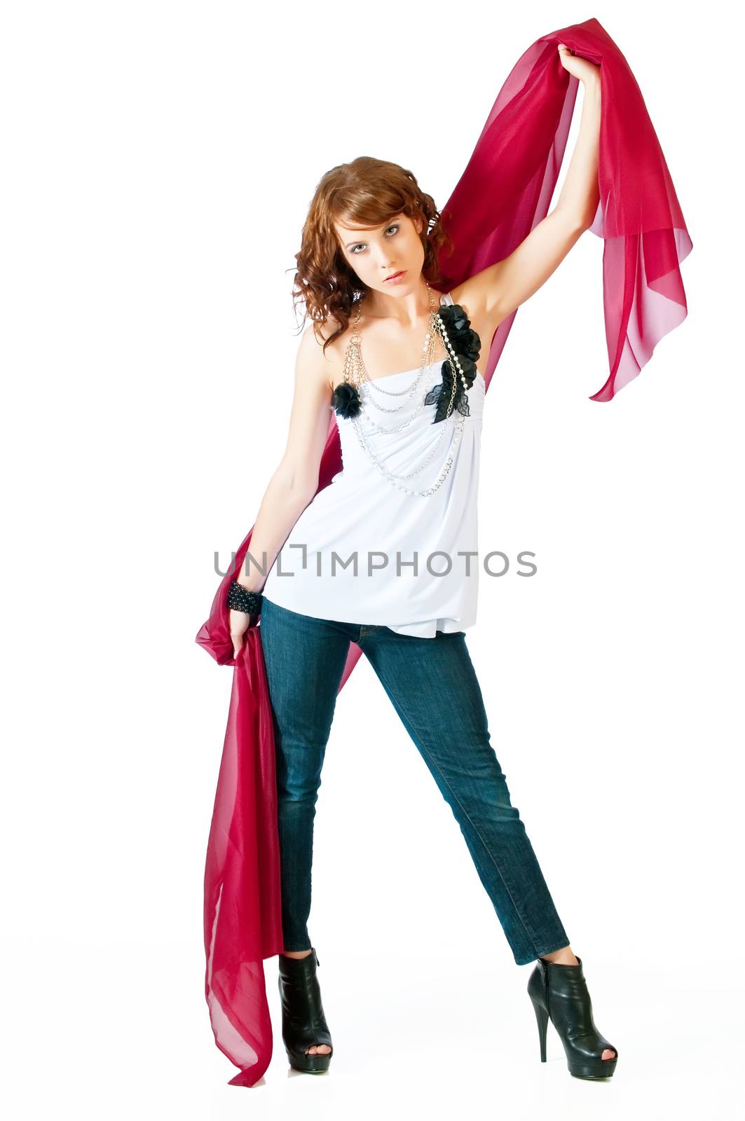 Beautiful young woman with red scarf against a white background and reflective floor.