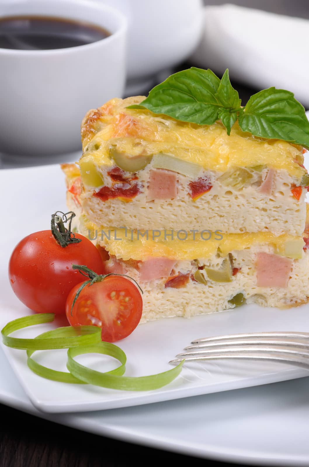 Omelet with vegetables and ham for breakfast close up