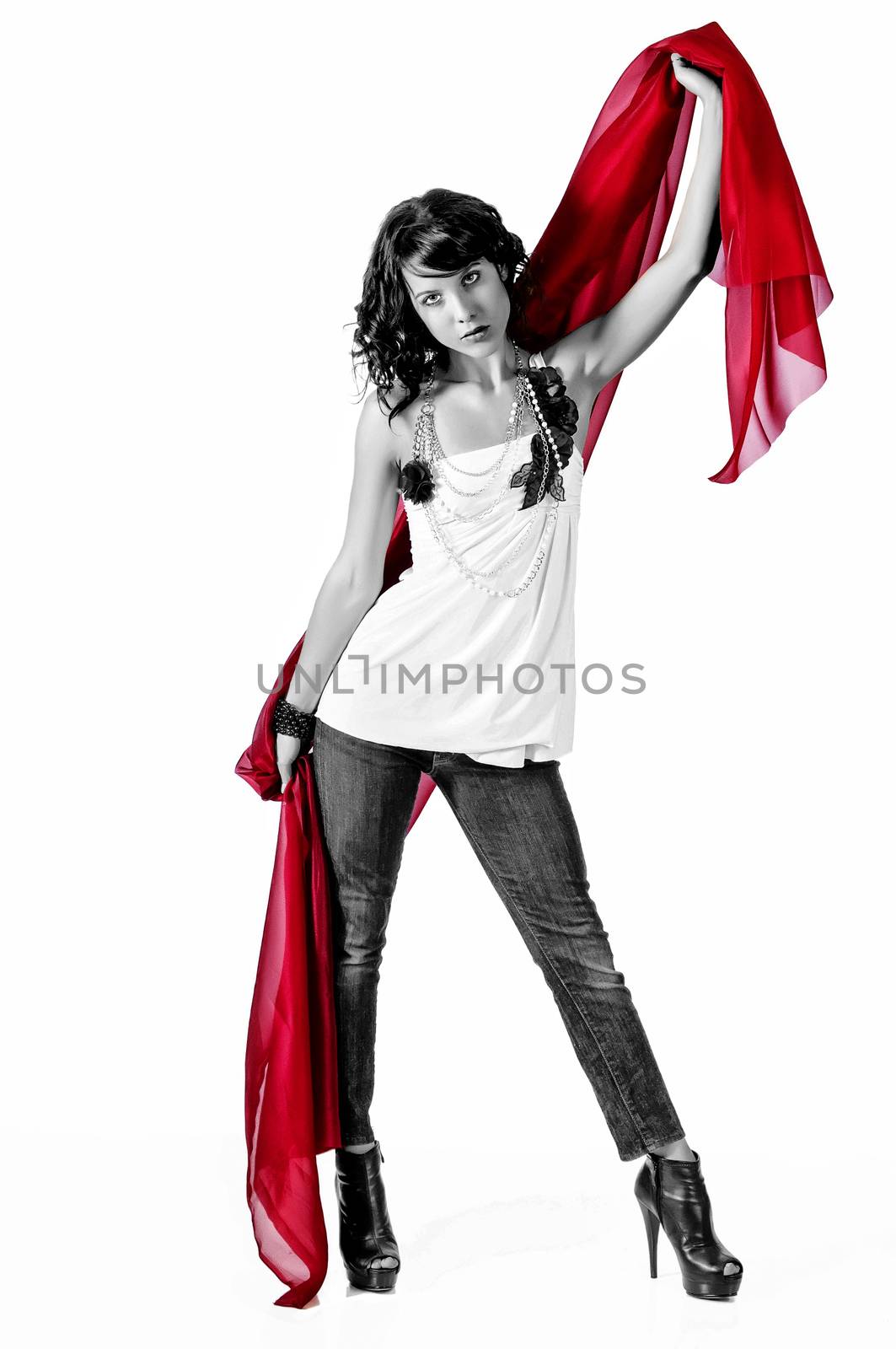 Beautiful young woman with red scarf against a white background and reflective floor.