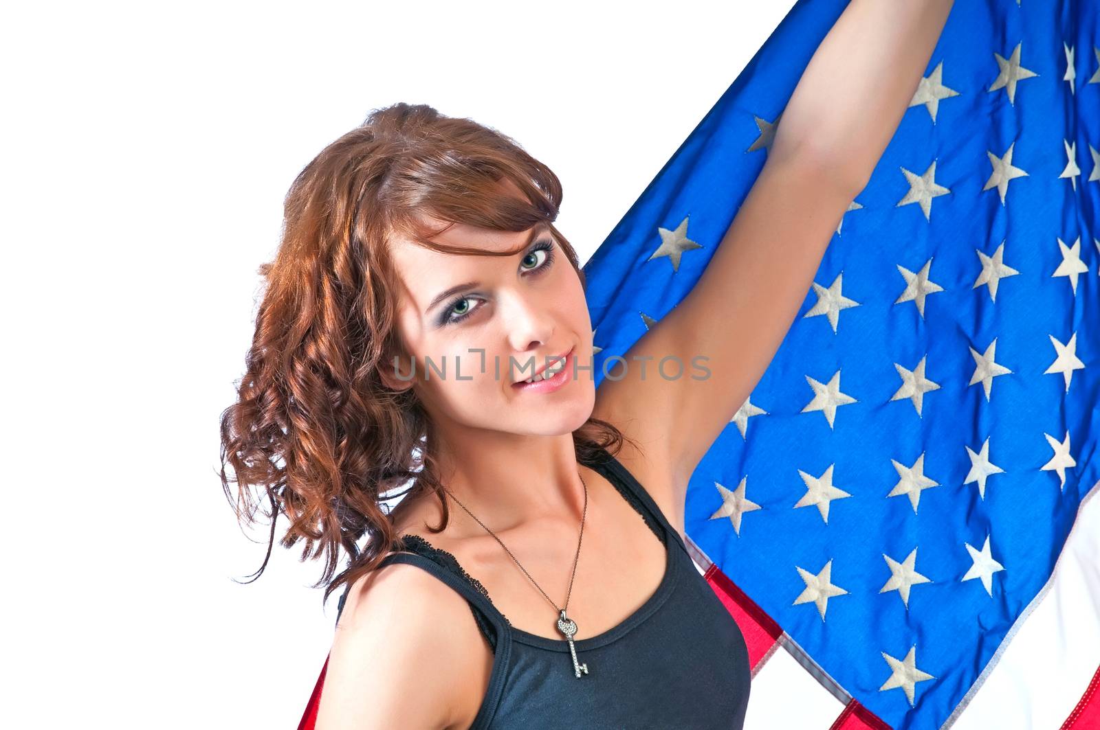 Proud beautiful young woman holding up her USA flag.