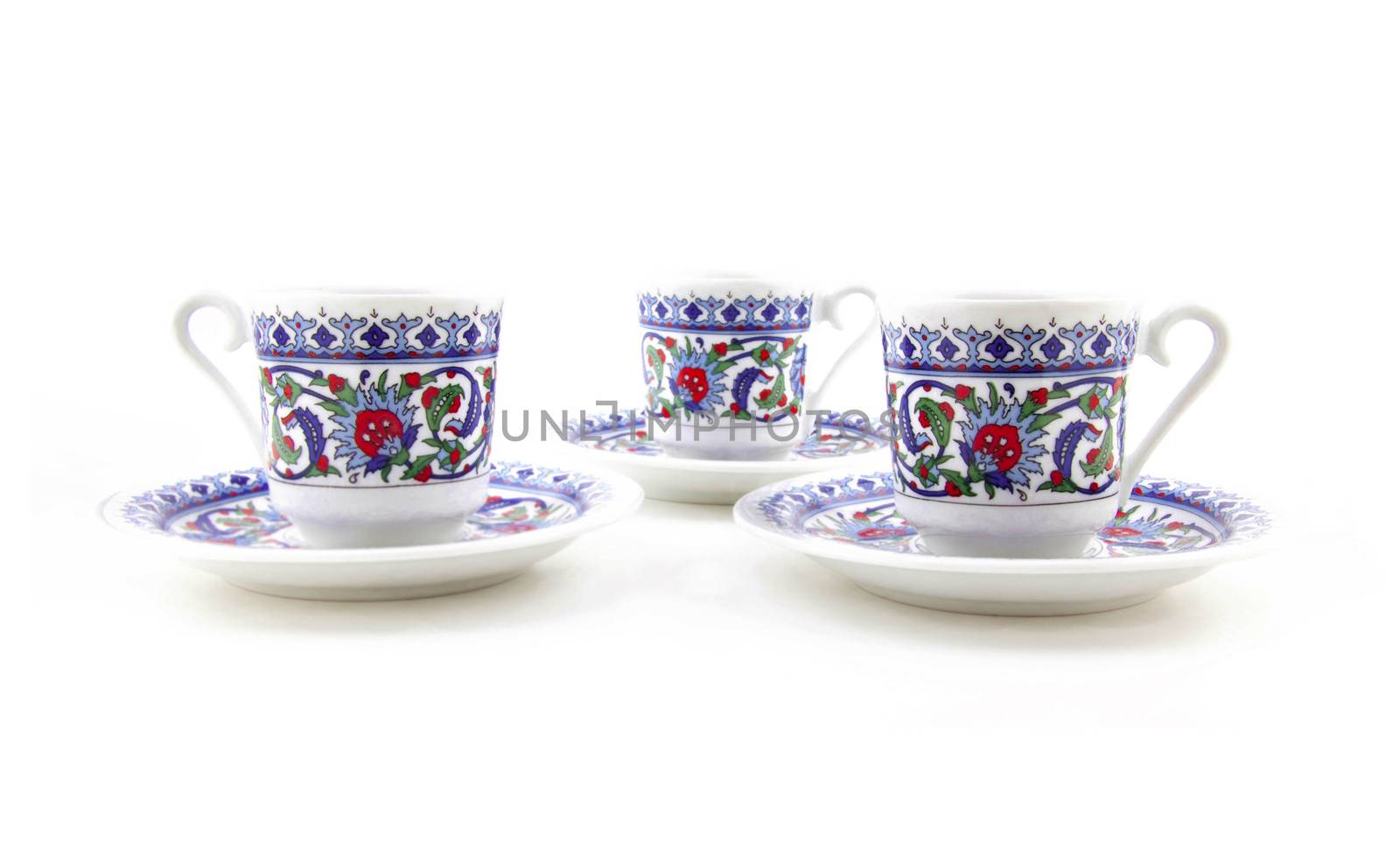 Ornamented teacups isolated on white