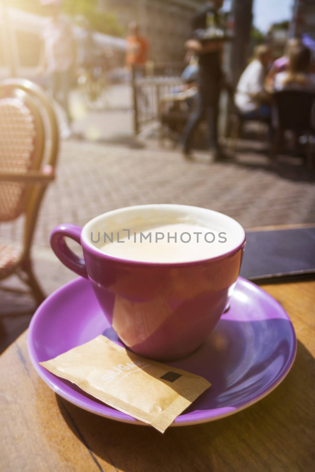 purple cup of coffee outdoors by magann