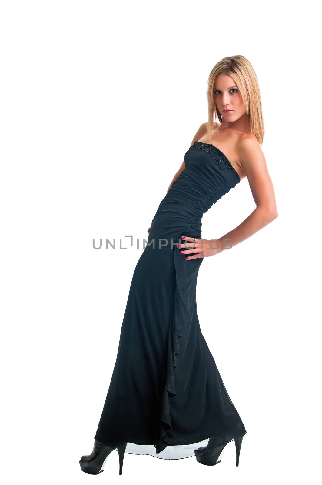 Pretty blonde confidently showing her close fitting gown against a white background