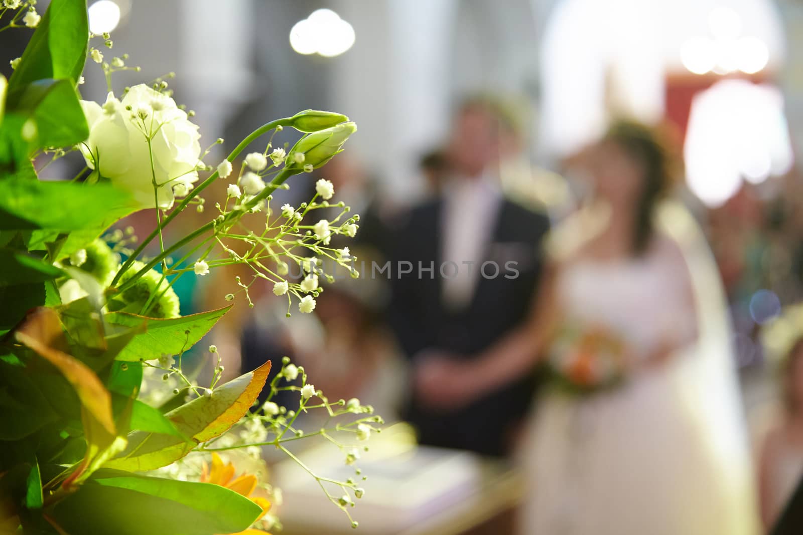 Wedding bouquet on a background of the bride and groom