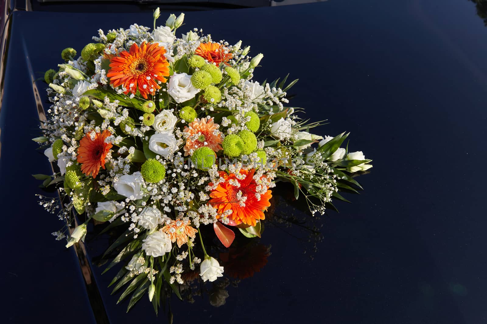 The wedding car decorated with flowers