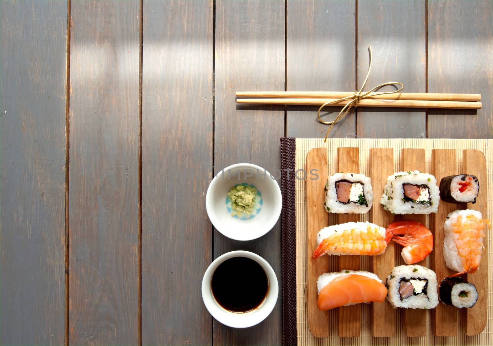 Selection of sushi seafood with rice on top of a wooden table background with space 