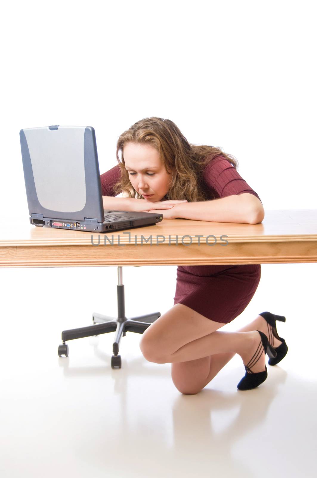 Young woman contemplates some results of calculations on her laptop.