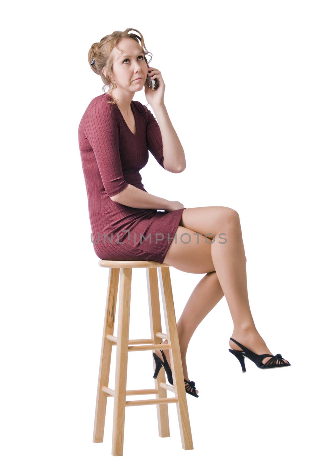 Young woman looks unhappy talking on the phone.