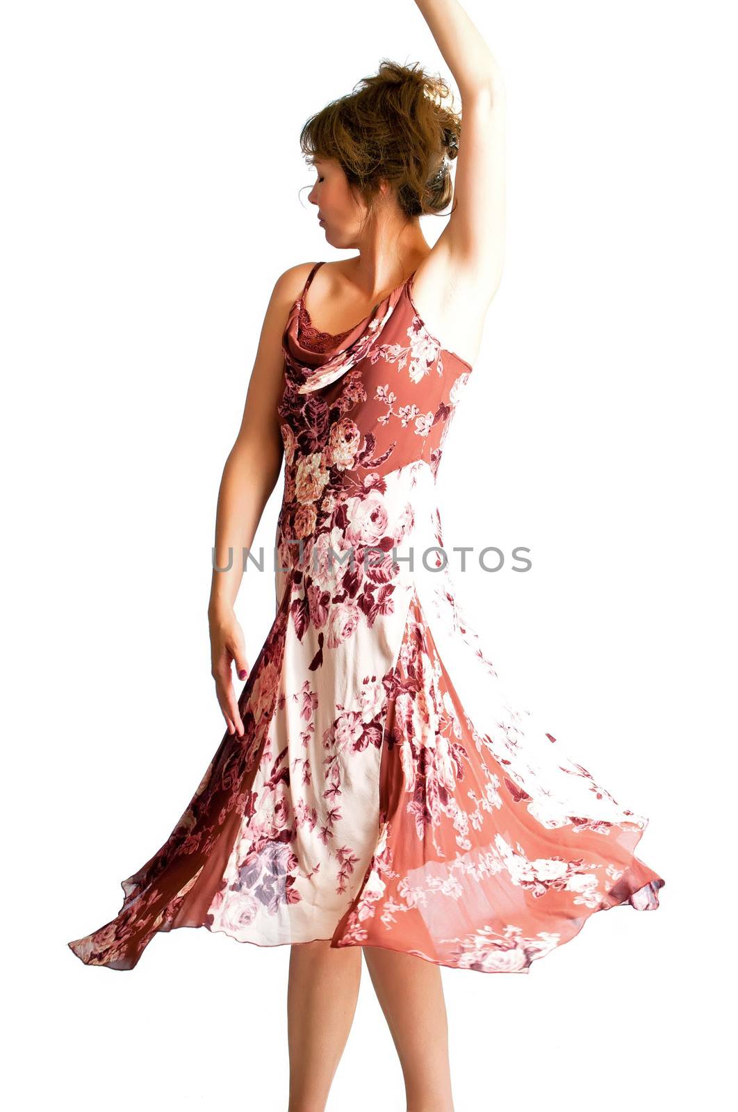 Pretty woman twirling with a full dress flared at the hem from the dance motion.