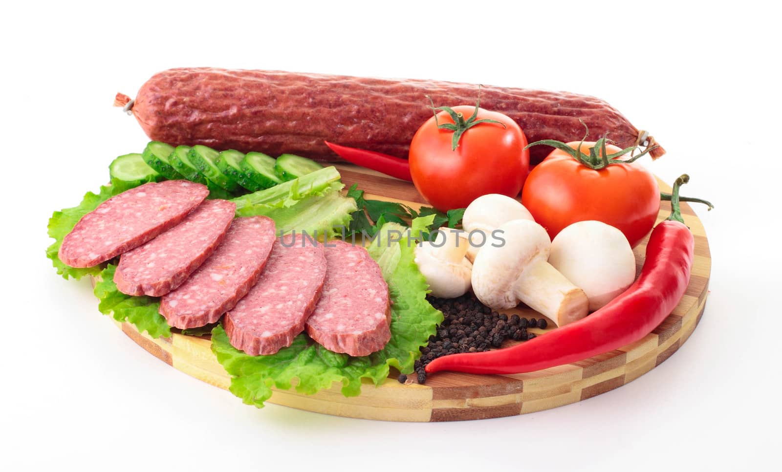 sliced sausage with vegetables on board by shutswis