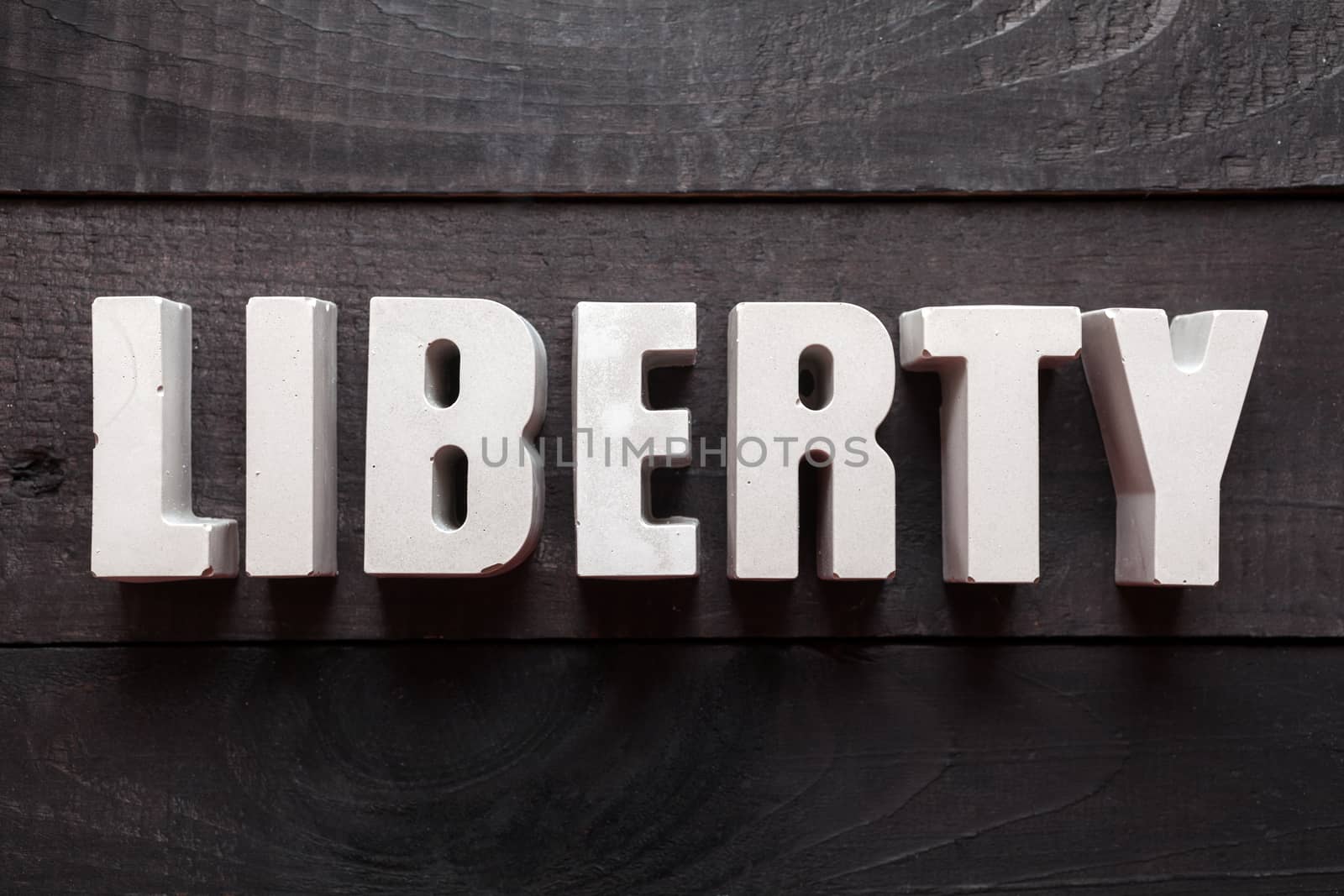 Letters from cement forming the word "Liberty"