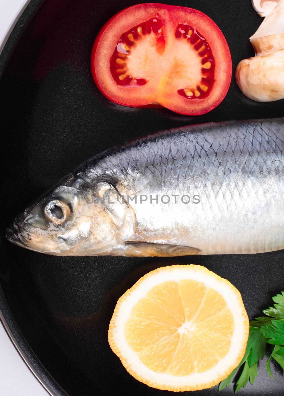 fish in pan with vegetables by shutswis