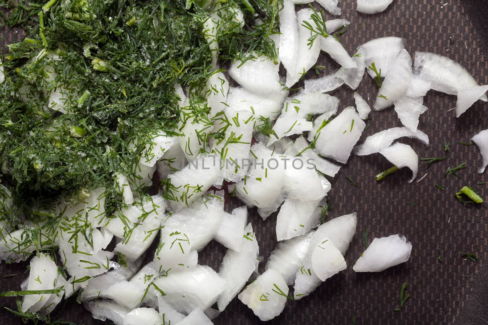 Onion, dill and oil in a frying pan