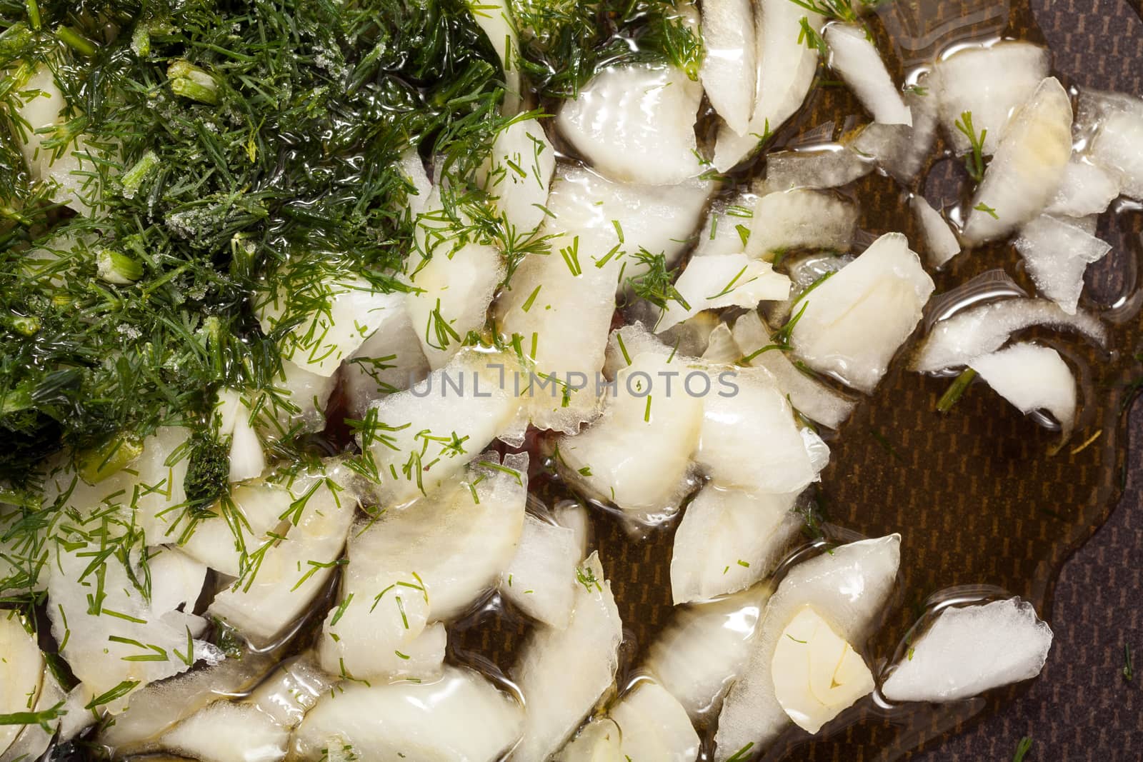 Onion, dill and oil in a frying pan