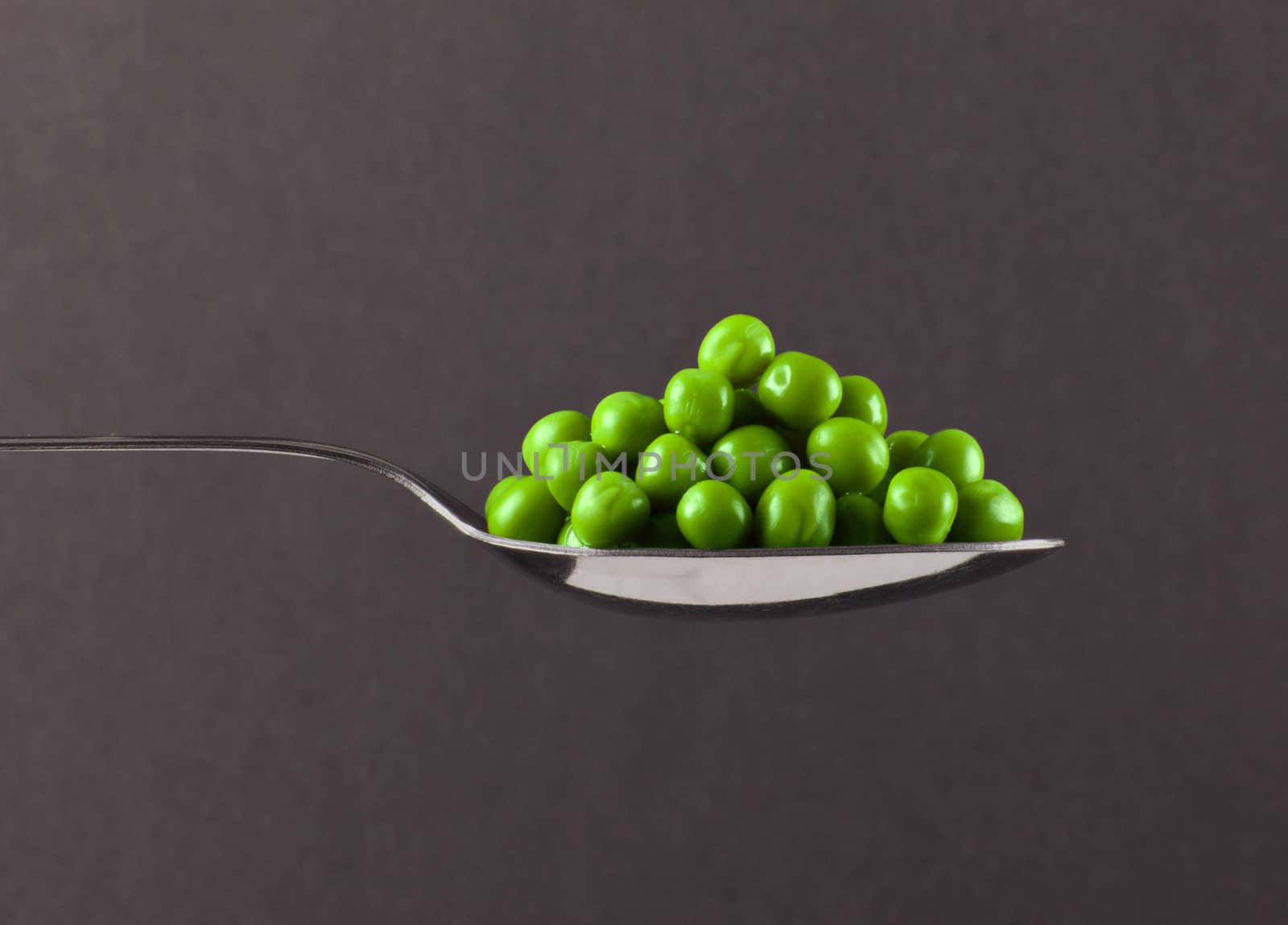 fresh frozen peas on spoon by shutswis