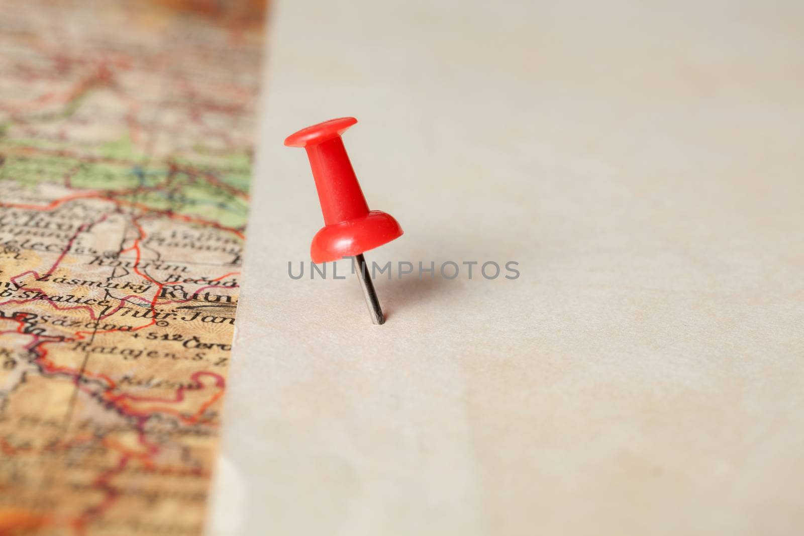 Red push pin showing the location of a destination point on a map. Ready for your message.