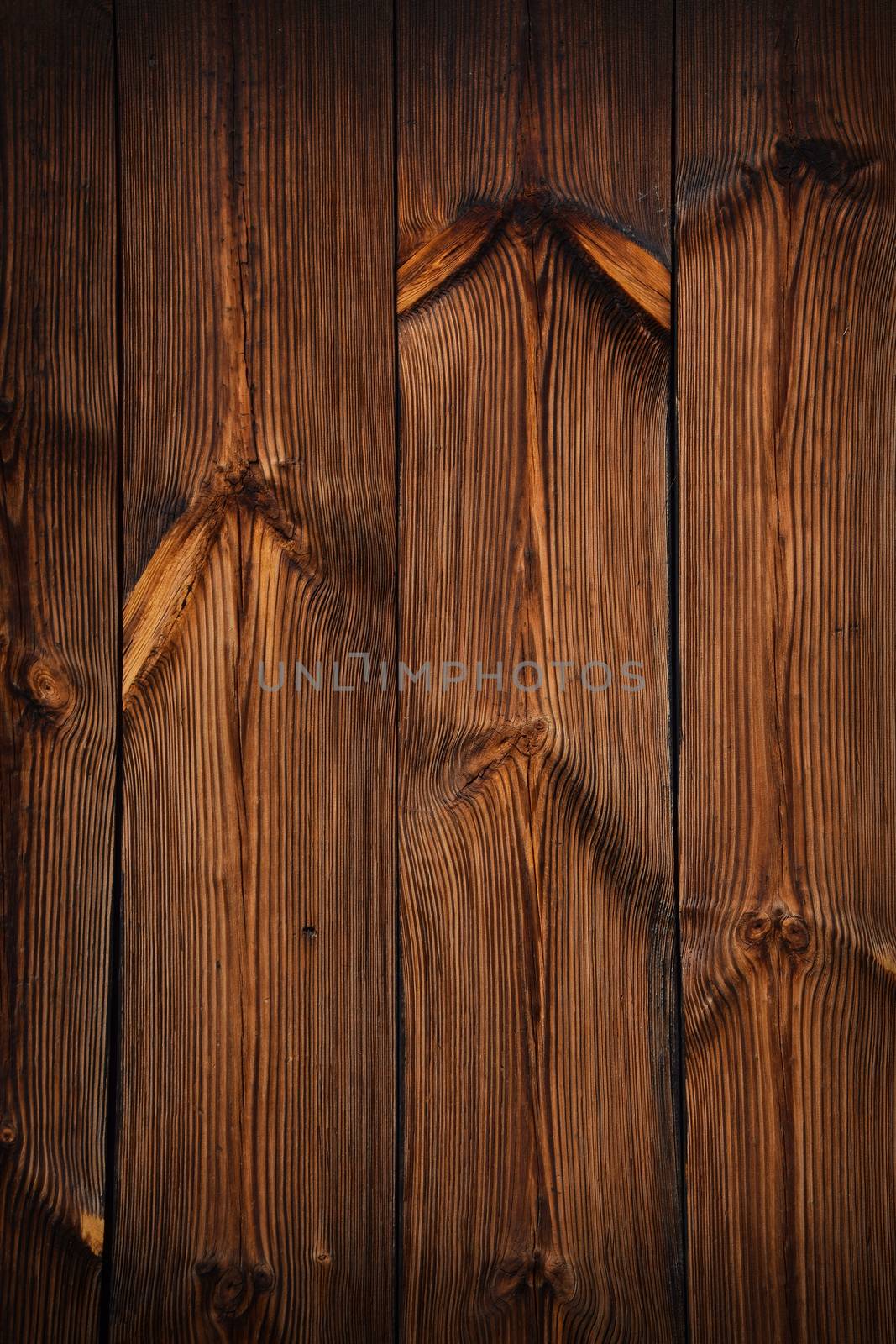 Brown vintage old wooden panel texture background with vertical unpainted aged planks and gaps and darker shaded border