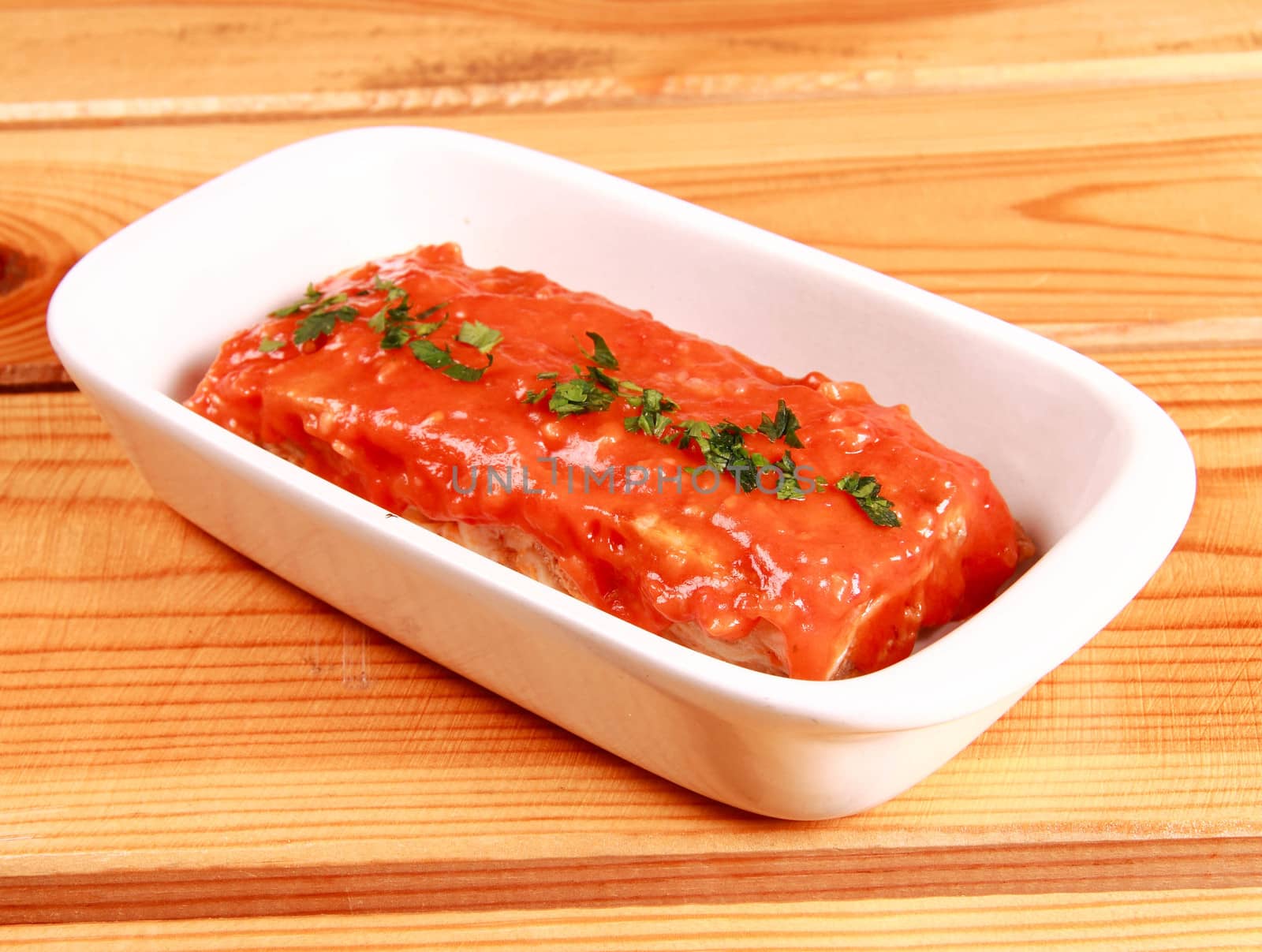 red lasagna isolated on wooden background