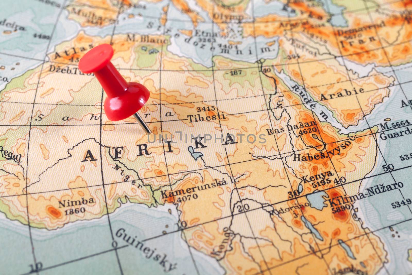 Red push pin showing the location of a destination point on a map. Afrika