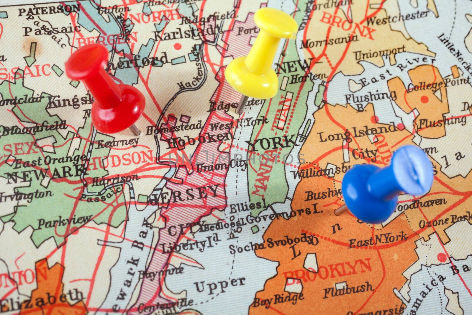 Red push pin showing the location of a destination point on a map. New York