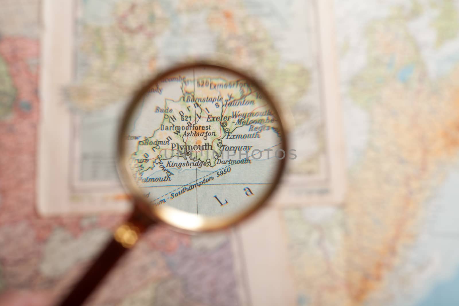Magnifying glass in front of a Plymouth map