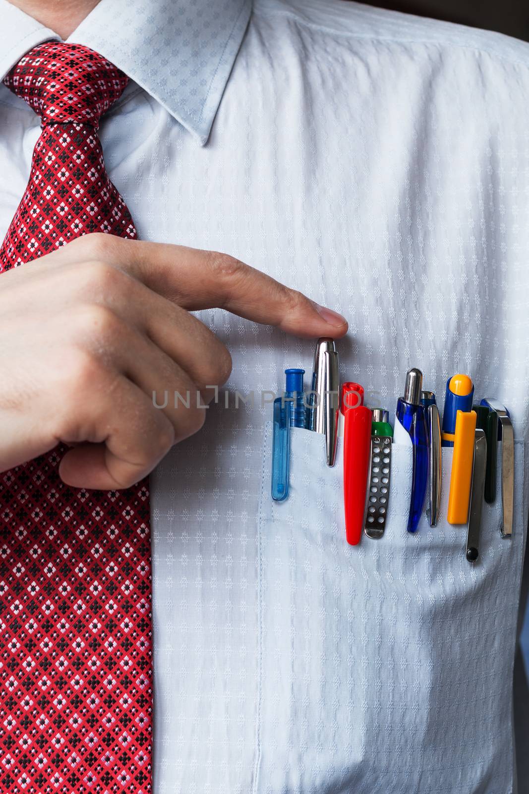 The elegant stylish businessman keeping a lot of colored pens in his breast pocket. Close up.