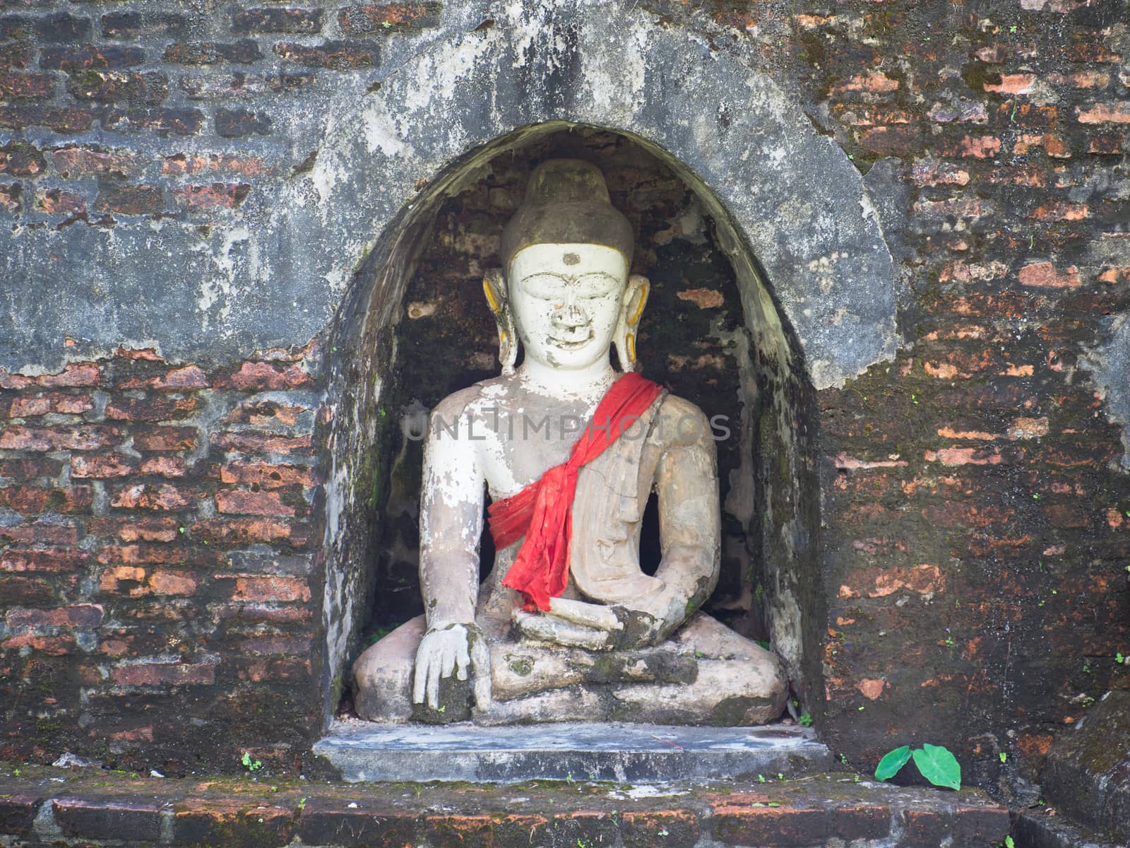 Buddha image in a small niche of an ancient stupa in Mrauk U, Rakhine State in Myanmar.