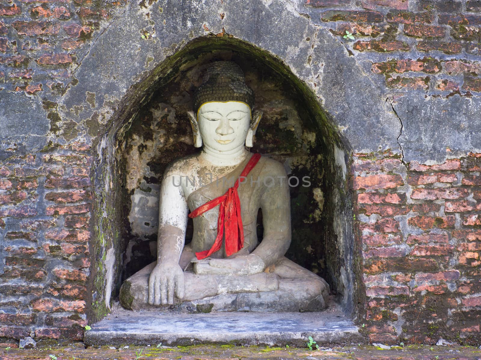 Buddha image in a small niche of an ancient stupa in Mrauk U, Rakhine State in Myanmar.