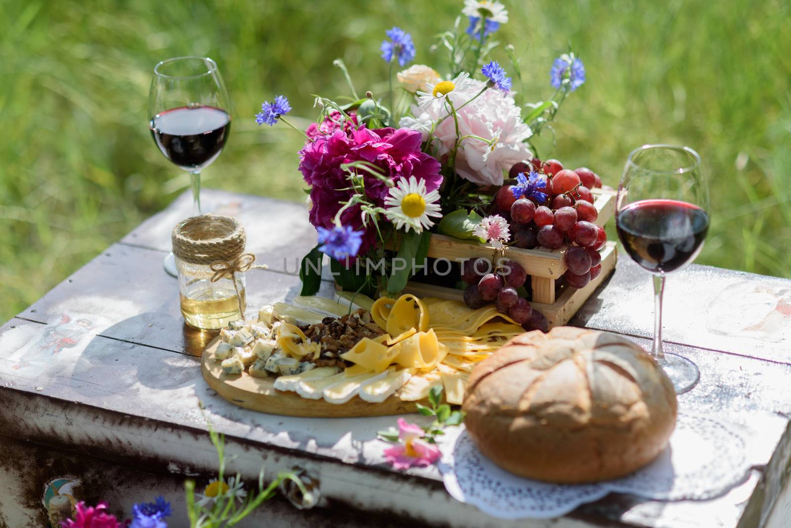 rustic decorative photo zone with suitcases, wine. cheese