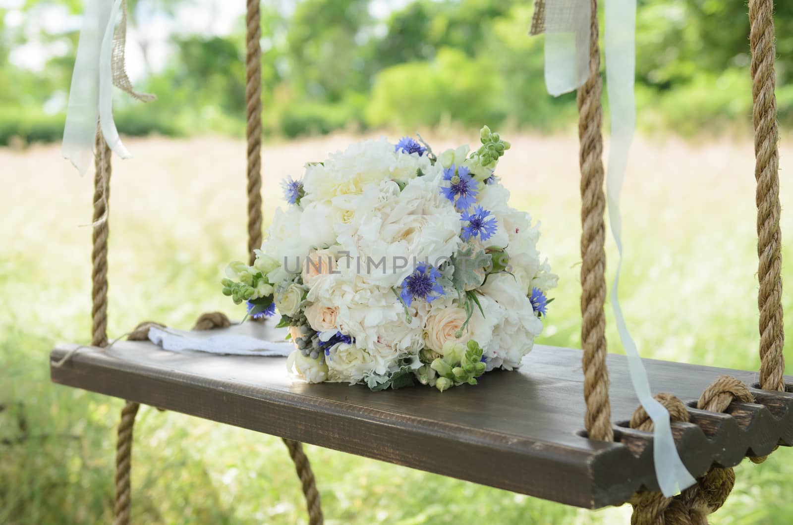 the bride's bouquet on wooden swing