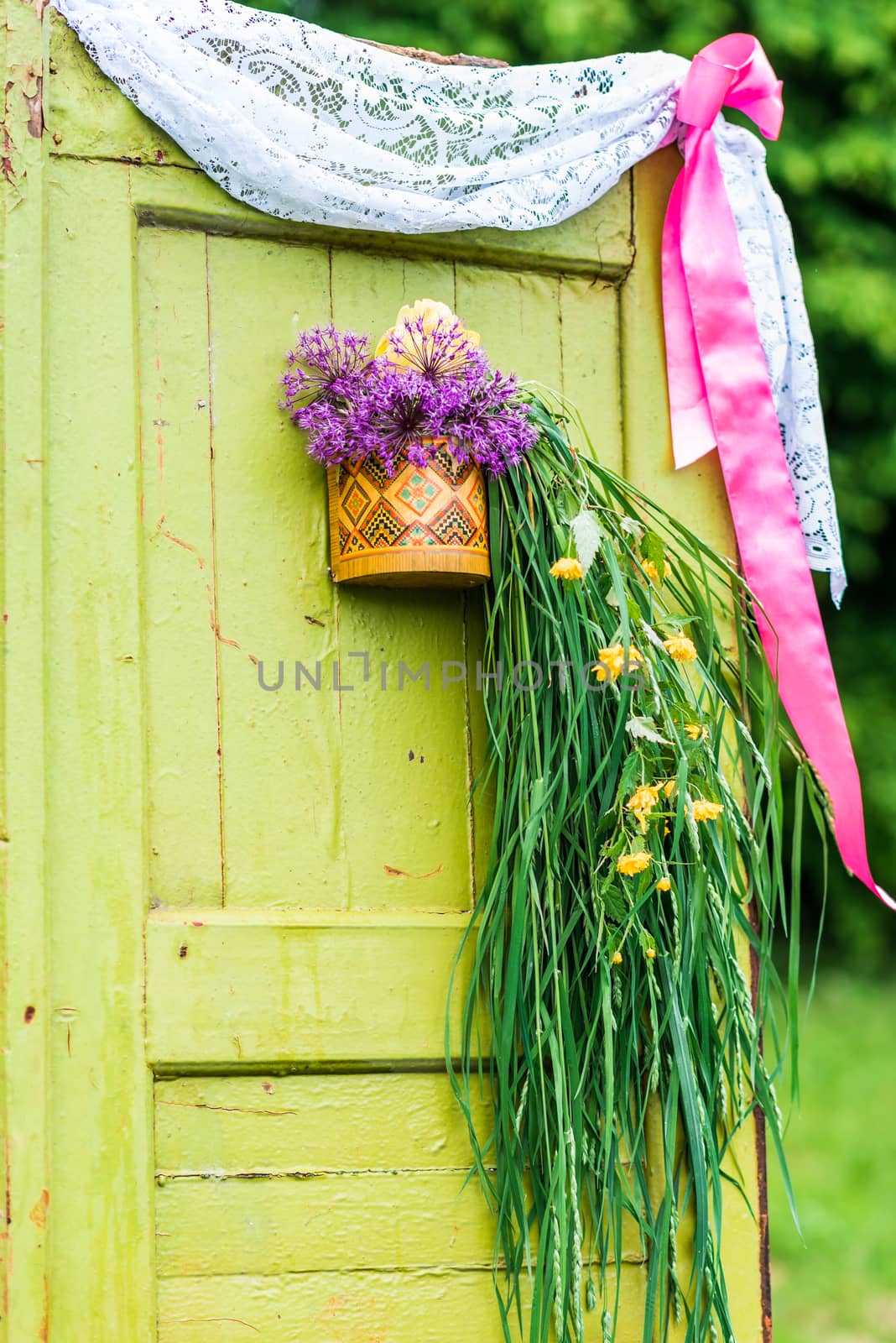 Antique wooden doors decorated with flowers in the garden