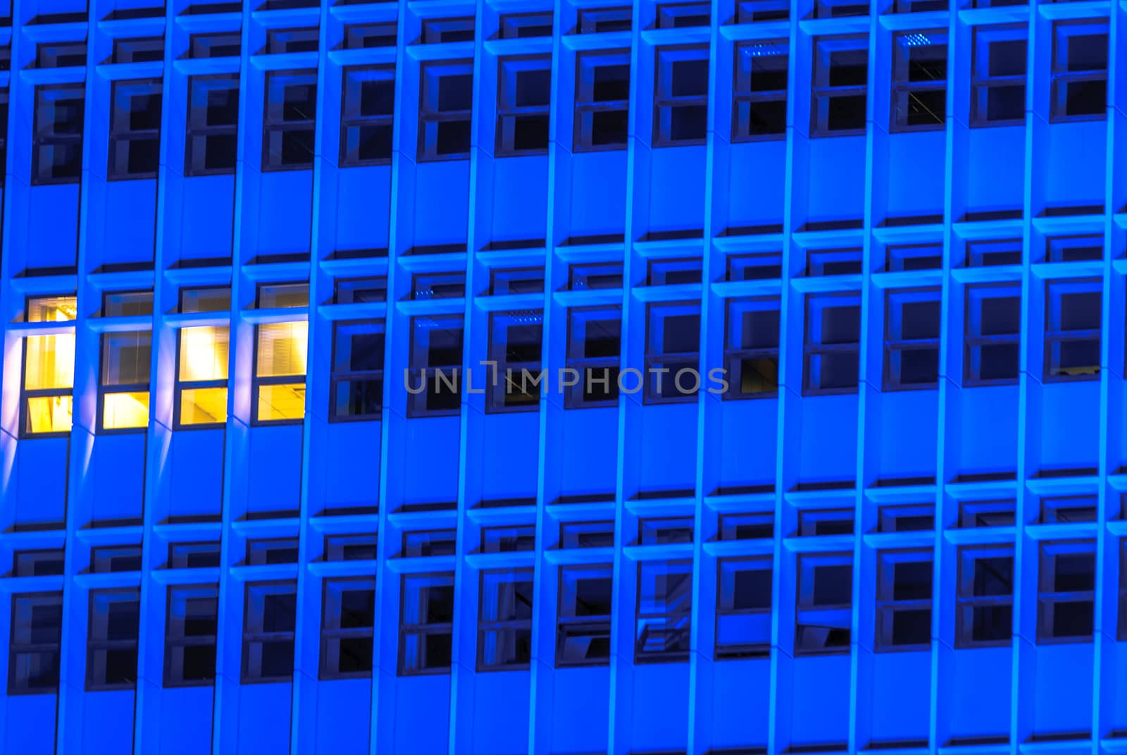 horizontal image of a Blue tall building with windows