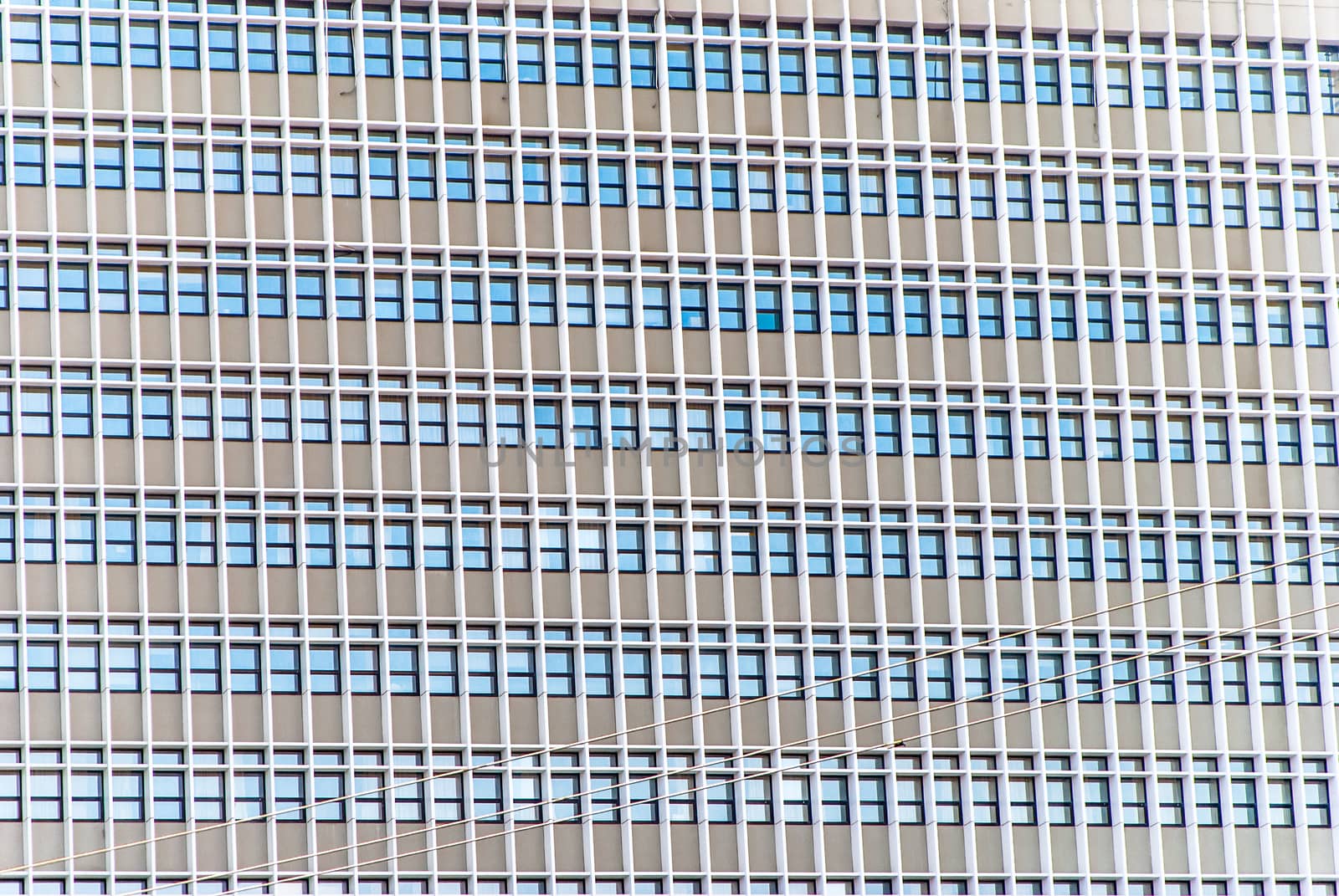 horizontal image of cement tall building with windows