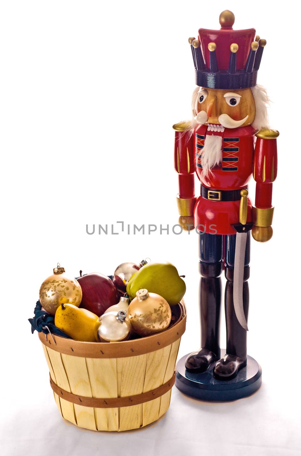 A nutcracker stands over a fruit basket
