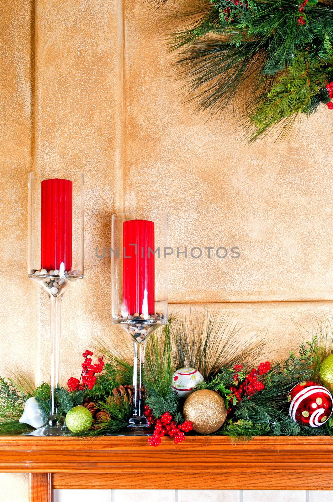 Fireplace mantle decorated with candles and garlands for Christmas