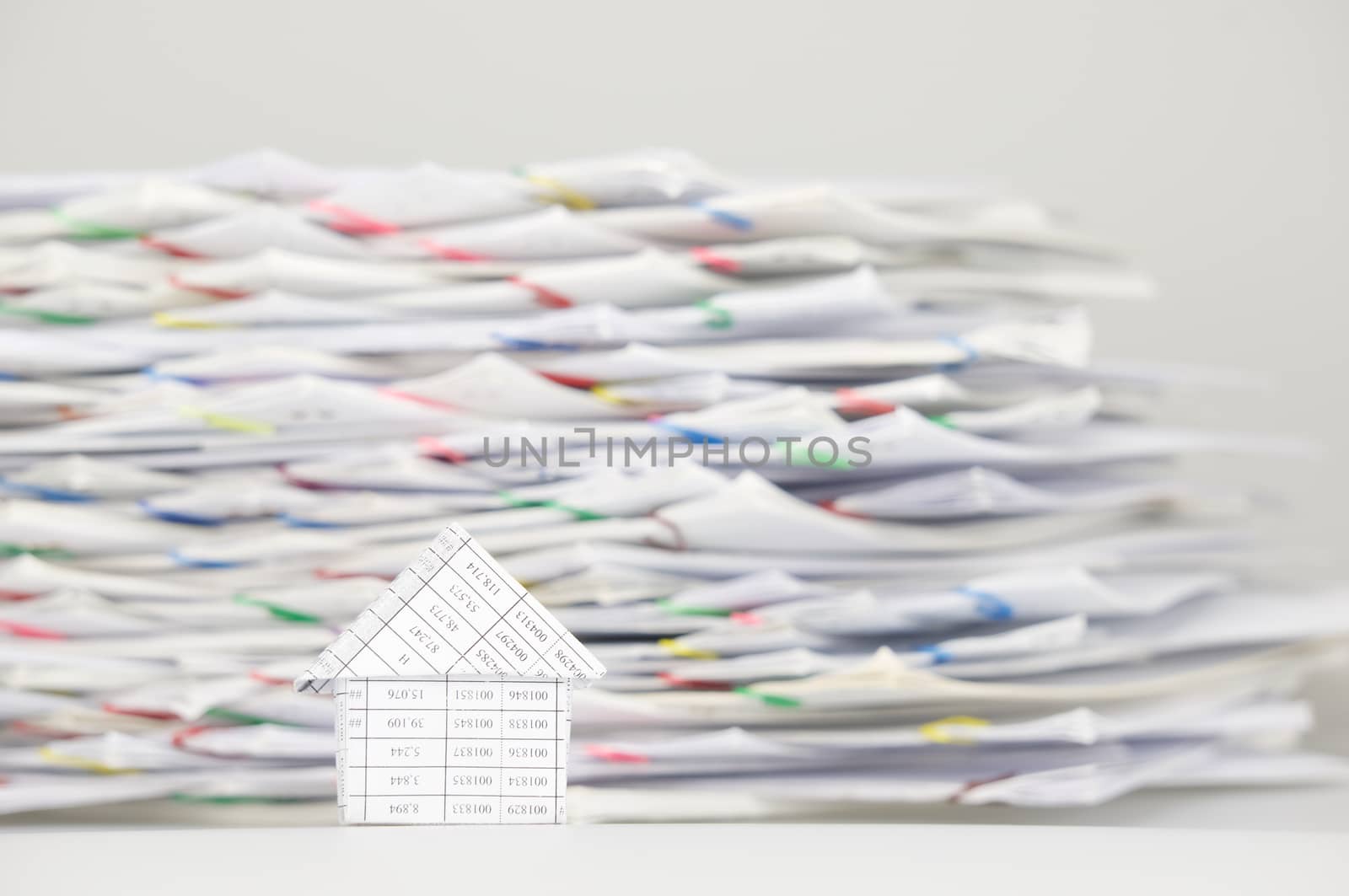 House on white table have blur stack overload of paperwork by eaglesky